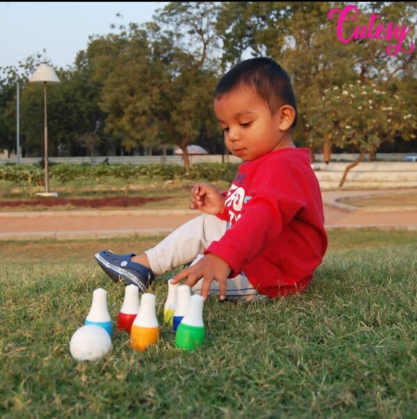 Kid playing with Cutesy Wooden Mini Bowling Set